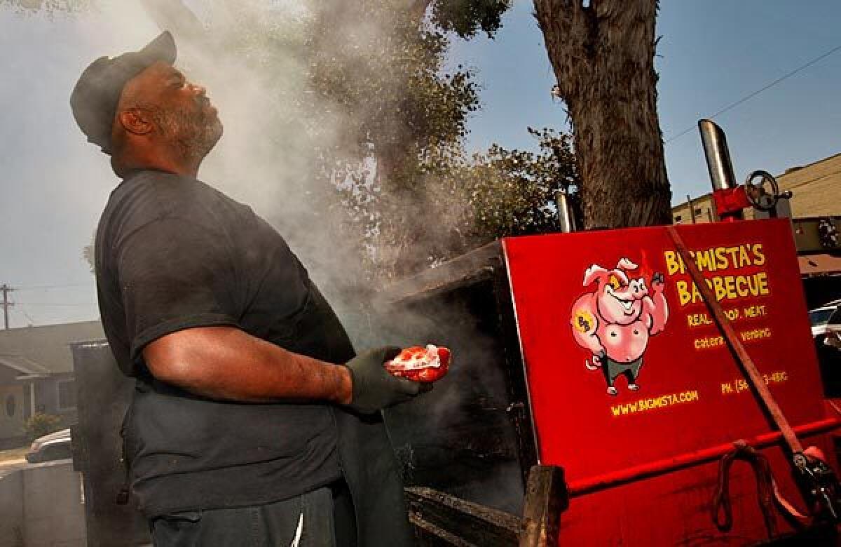 Bigmista himself, Neil Strawder, prepares to toss some links on the grill.