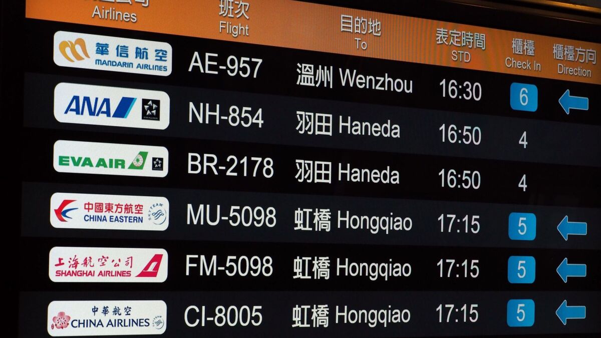 A flight information board at the Taipei Songshan Airport in Taiwan shows a China Eastern Airlines logo among others on Jan. 21, 2018.