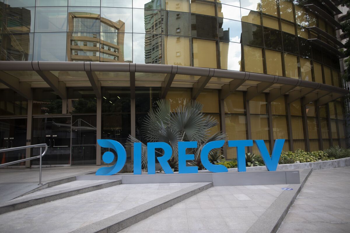 A DirectTV logo identifies the company's headquarters in Caracas, Venezuela, Friday, May 22, 2020. Venezuela’s high court ordered on Friday the immediate seizure of all DirecTV property, days after the U.S. firm abandoned its services in the South American nation, citing U.S. sanctions. (AP Photo/Ariana Cubillos)