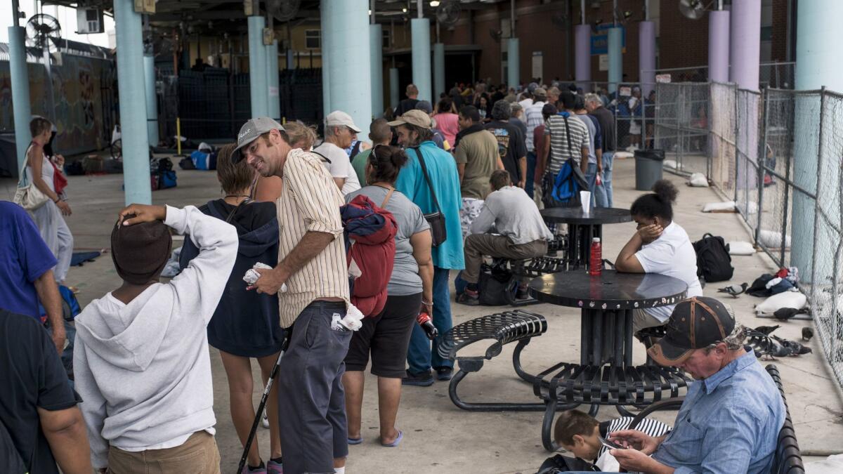 People line up for dinner at the Courtyard, an open-air "safe sleeping space" adjacent to the Haven for Hope campus. (Matthew Busch / For The Times)