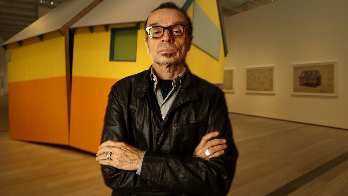 Artist Daniel Joseph Martinez stands before one of his sculptures at the Los Angeles County Museum of Art in 2017.