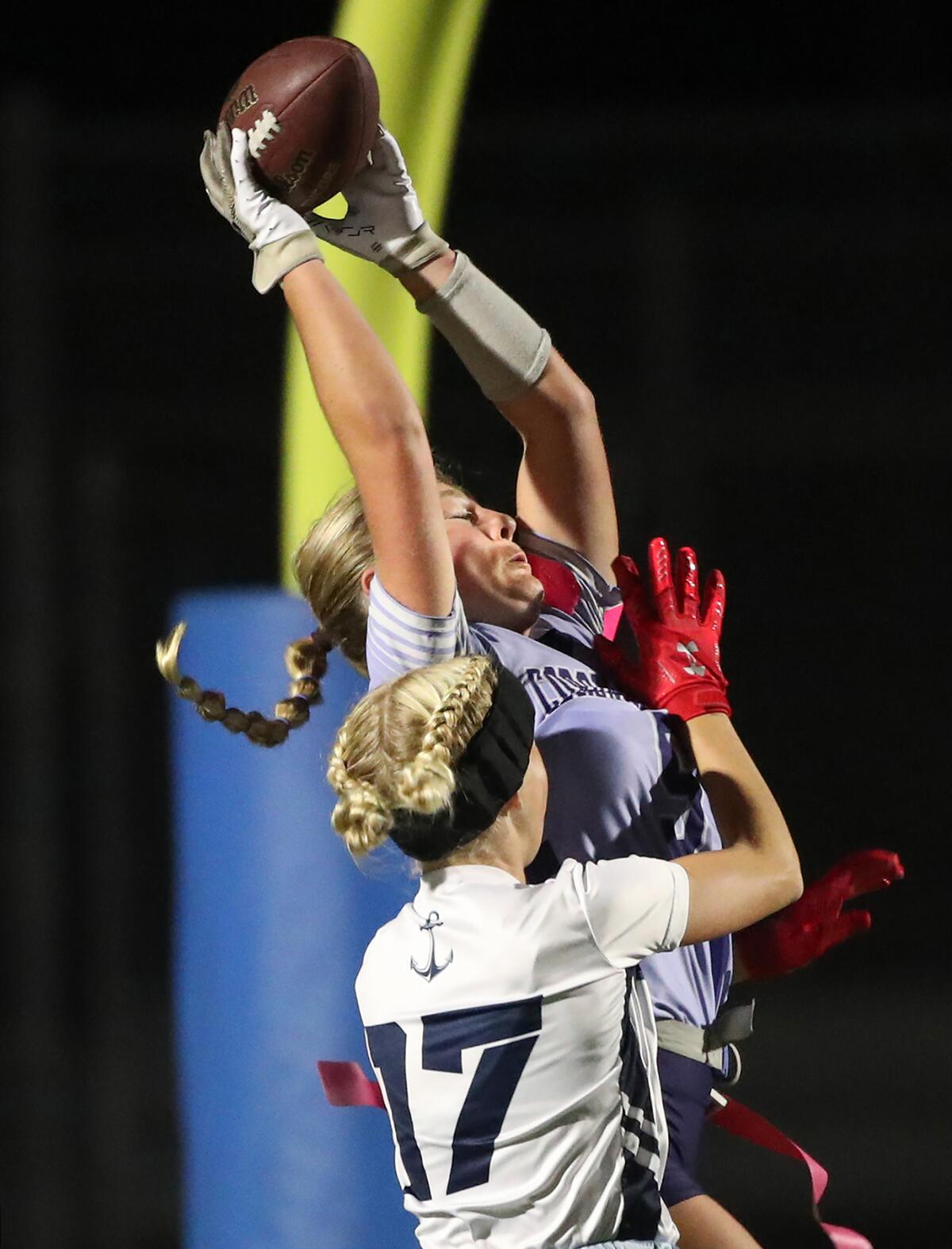 Corona del Mar's Anna Sofia Dickens (5) makes a leaping touchdown catch in front of Newport Harbor's Blakely Irvine (17).