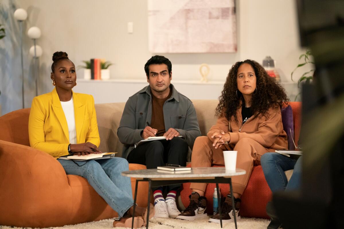 Issa Rae Kumail Nanjiani and Gina Prince-Bythewood sit together on a couch listening to a film pitch.