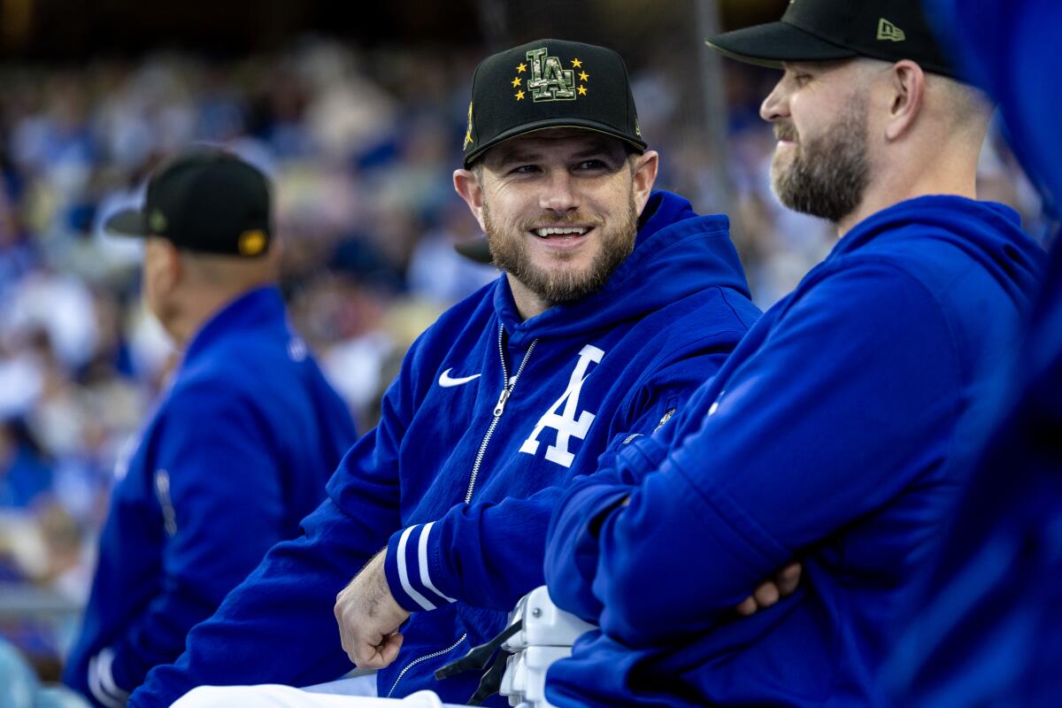 The Dodgers' Max Muncy chats in the dugout during the game against the Reds at Dodger Stadium on May 18.
