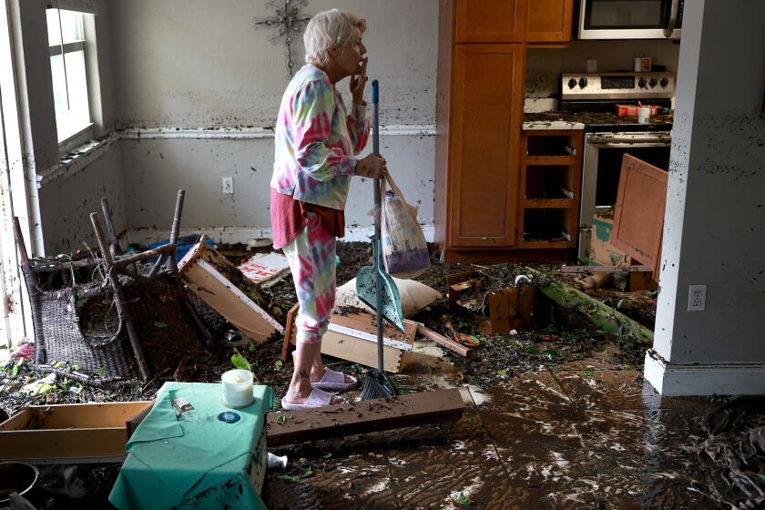Stedi Scuderi looks over her apartment after flood water inundated it when Hurricane Ian passed through the area.