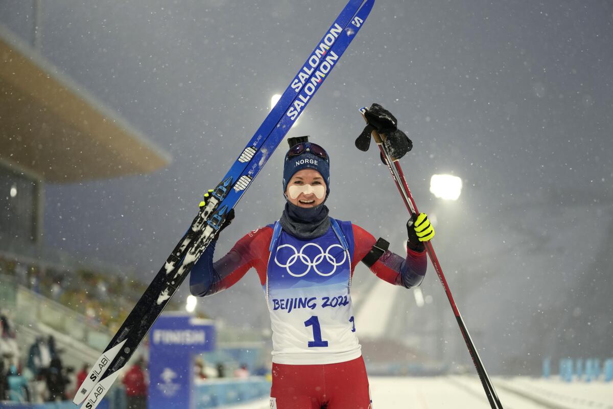 Marte Olsbu Roeiseland of Norway holds her skis after winning.