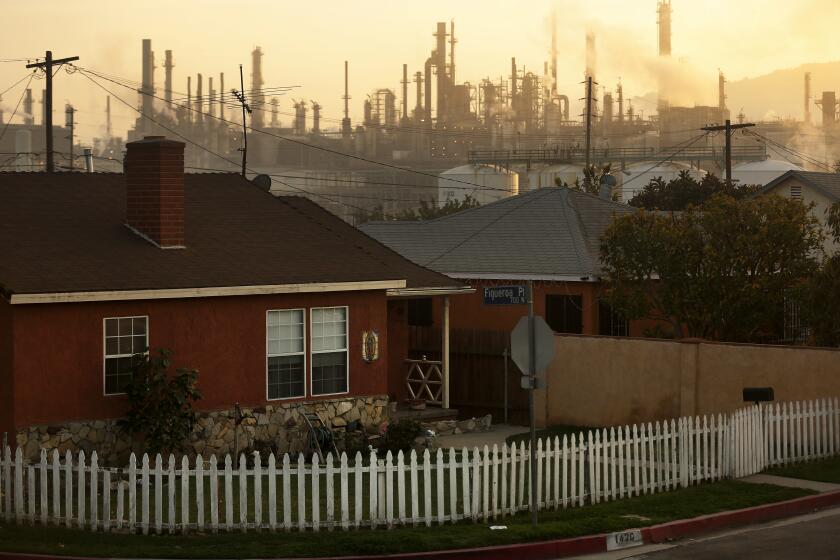 WILMINGTON, CA -- TUESDAY, MARCH 1, 2016 -- The Phillips 66 refinery looms over a Wilmington neighborhood where some long-time residents feel their health issues might stem from their proximity to the refinery. The Union Oil Company of California built the original refinery in 1919 between the old Anaheim road and the port, years before homes were constructed to form the neighborhood. ( Rick Loomis / Los Angeles Times )