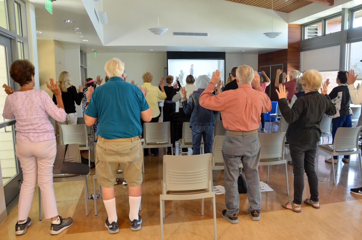 Attendees take part in the interactive portion of the UCI Health lecture fall prevention at OASIS Senior Center.