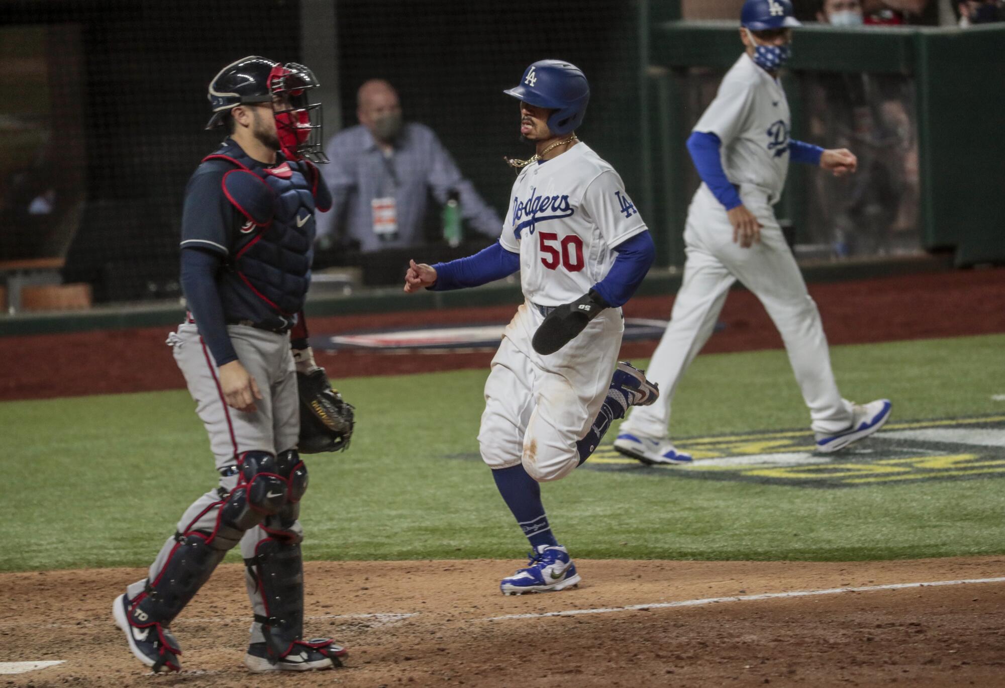 Dodgers right fielder Mookie Betts scores on a double by Corey Seager in the ninth inning.