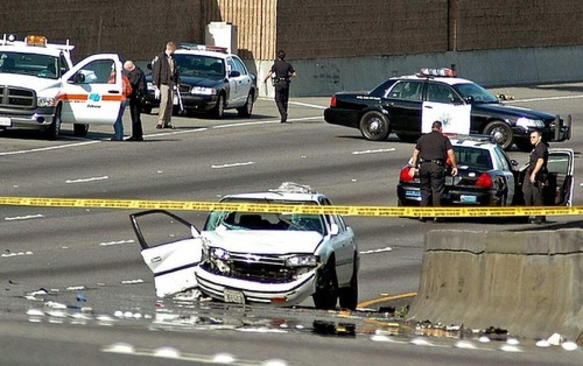 Los Angeles police investigate the site of a shooting-related accident on the 101 Freeway on March 30. Marlon Gordillo Sical, 20, the driver of the white Honda, died after being shot in the head. At least seven car-to-car shootings in the six weeks prior to this incident have resulted in five deaths and several injuries while bringing commuter corridors to a grinding halt as authorities search for clues.