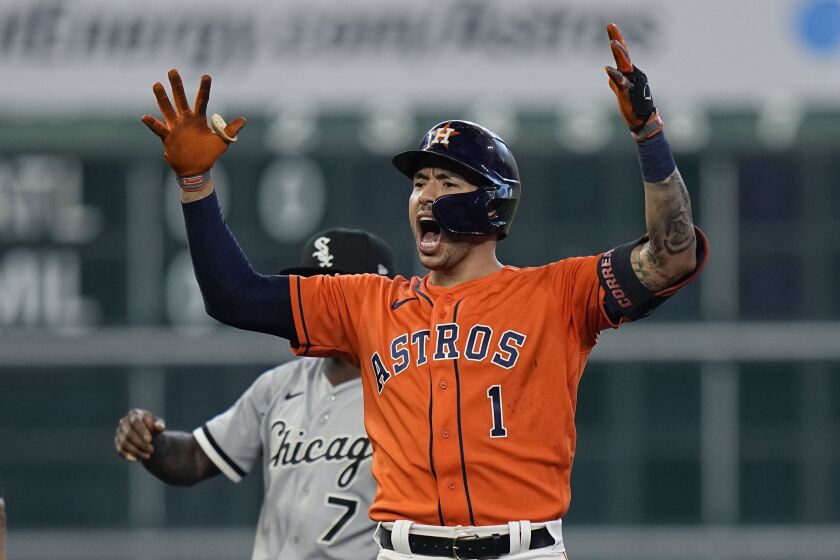 Houston Astros shortstop Carlos Correa (1) celebrates after hitting a two-run double against the Chicago White Sox during the seventh inning in Game 2 of a baseball American League Division Series Friday, Oct. 8, 2021, in Houston. (AP Photo/David J. Phillip)