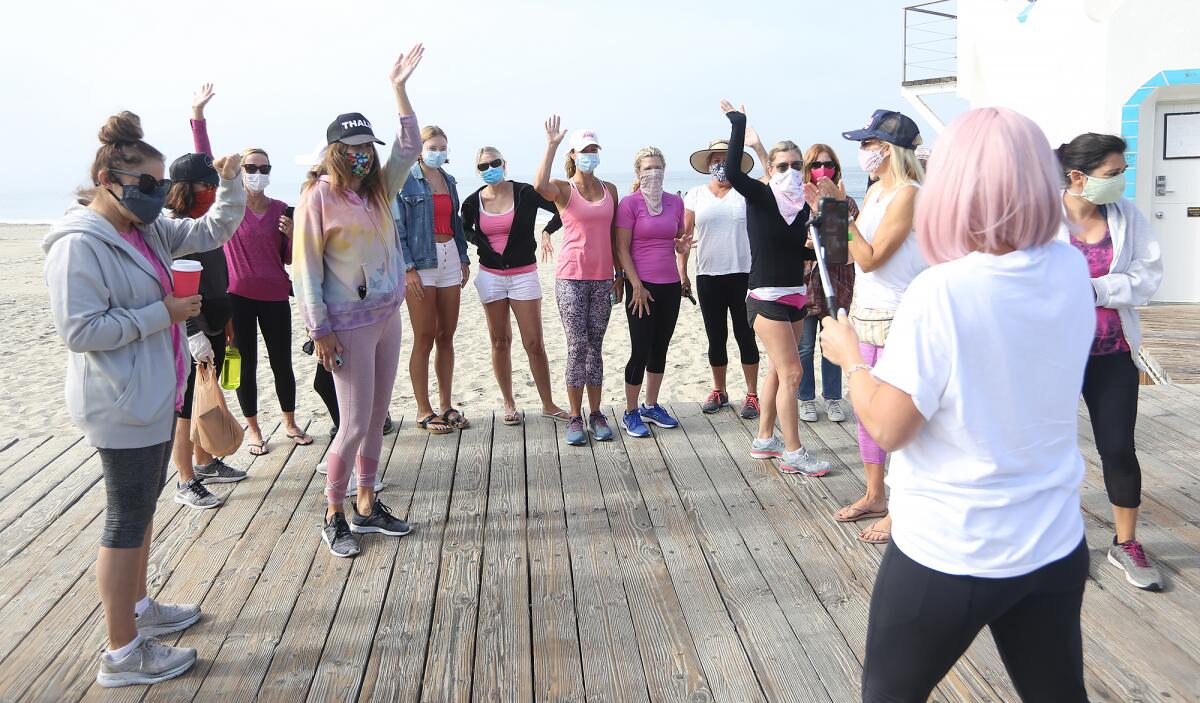 Sharael Kolberg of Laguna Beach, far right, cheers with her team during her "50 for the Cure" walk.