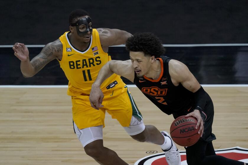 Oklahoma State's Cade Cunningham drives on Baylor's Mark Vital during a Big 12 tournament semifinal game March 12, 2021.