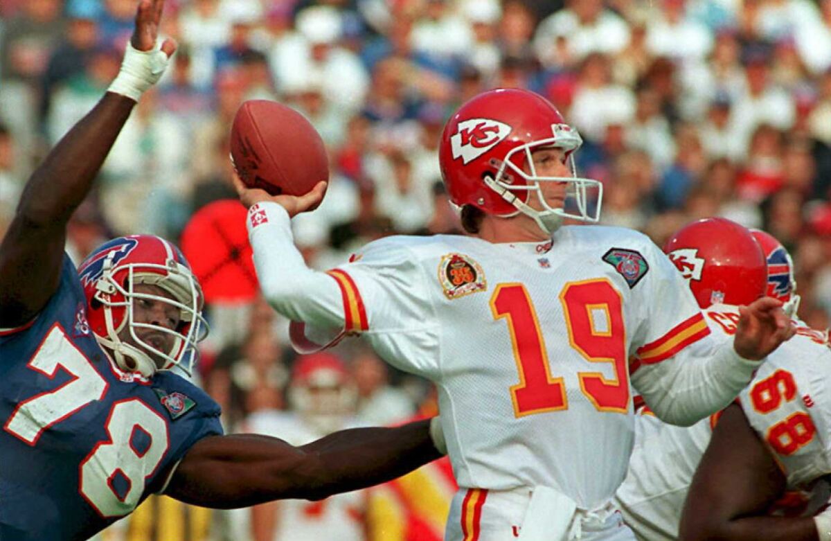 Chiefs quarterback Joe Montana looks to pass under pressure from Bills defensive end Bruce Smith on Oct. 30, 1994