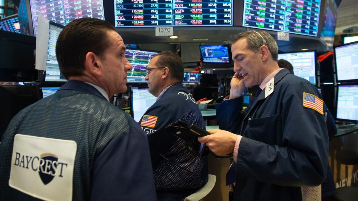 Traders work on the floor of the New York Stock Exchange.