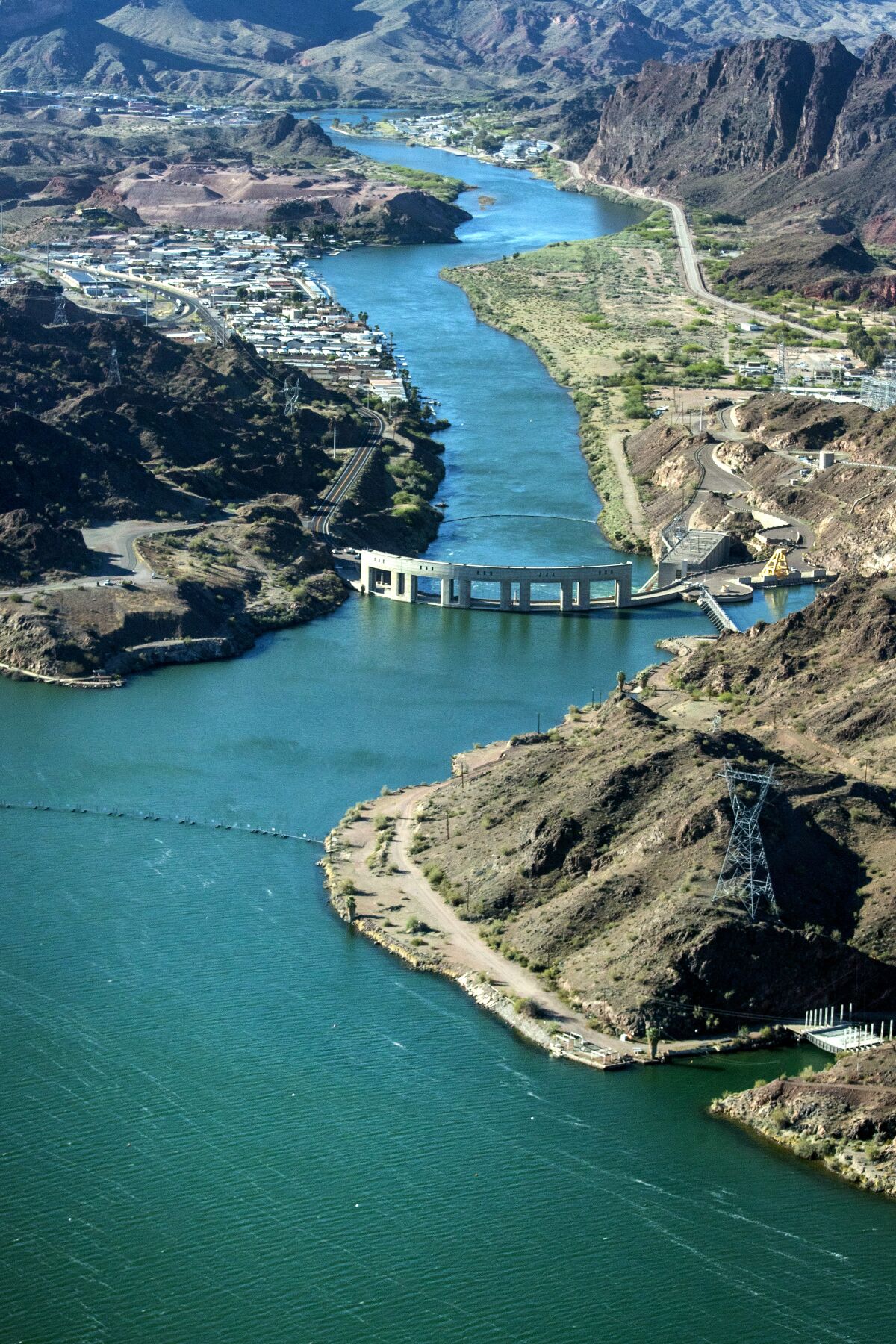 A vertical frame of a river winding through arid, hilly landscape
