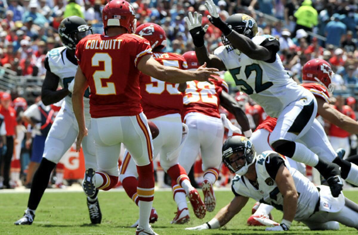 Jaguars linebacker J.T. Thomas (52) is about to block a punt by the Chiefs' Dustin Colquitt in the first half Sunday in Kansas City.