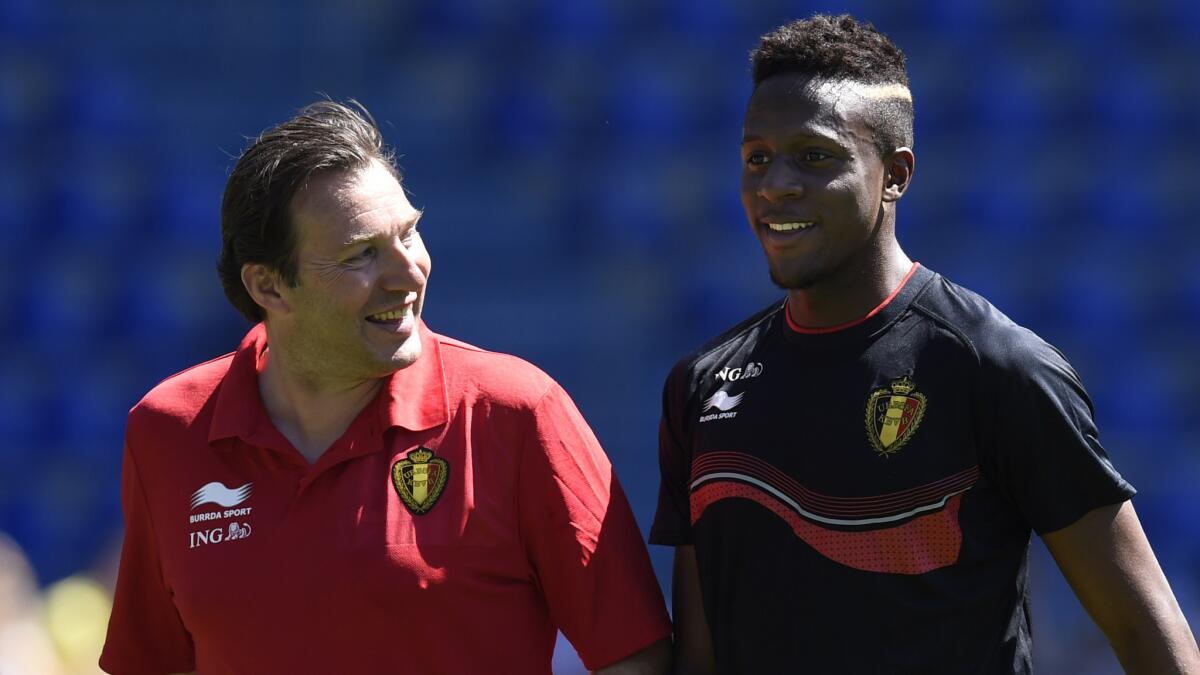 Belgium Coach Marc Wilmots, left, speaks with Belgian striker Origi Divock during a training session on May 20. The youthful Belgian World Cup squad is hoping to usher in a new golden age for the country in international soccer.