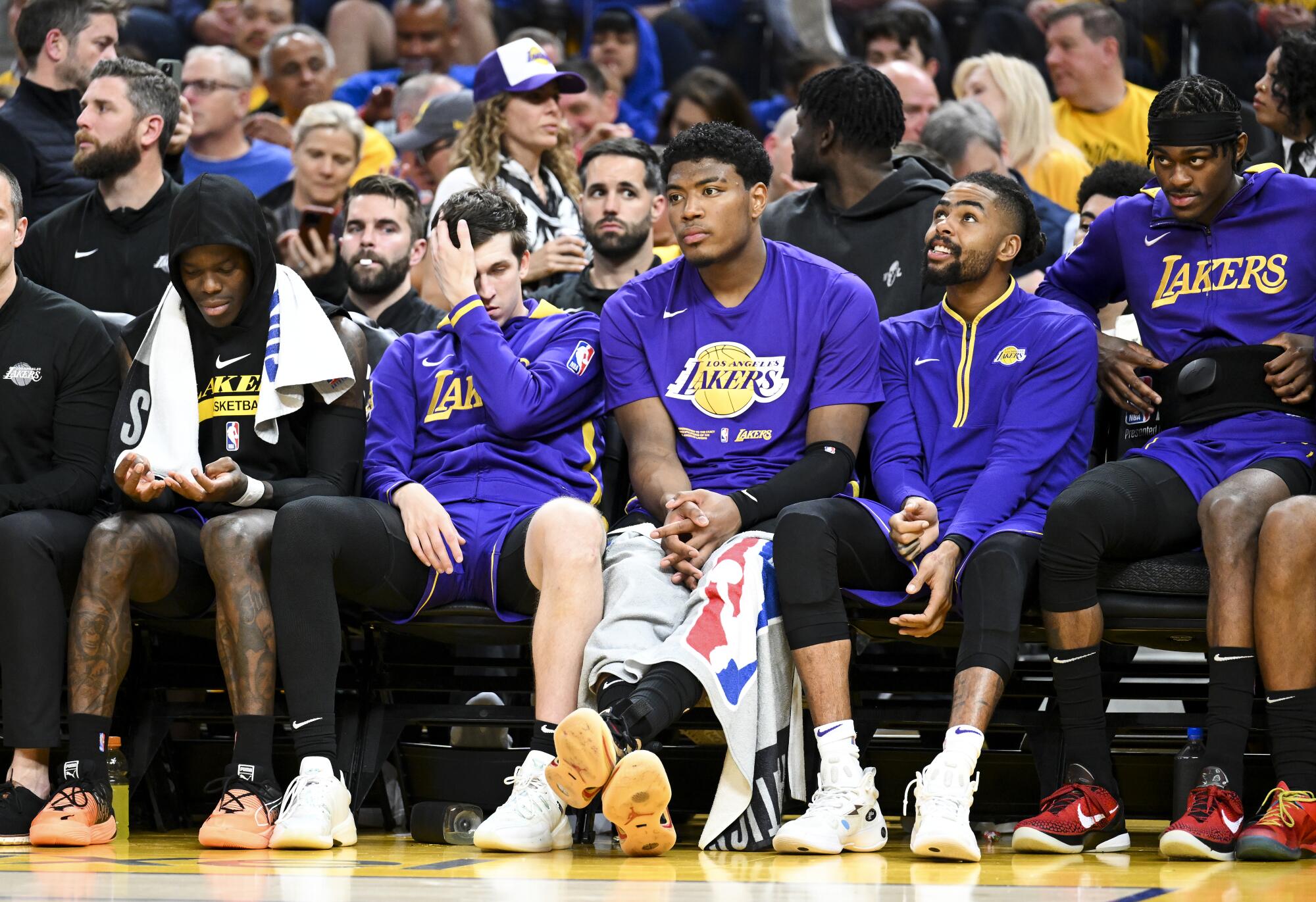 Lakers' Dennis Schroder sits with Austin Reaves, Rui Hachimura, D'Angelo Russell, and Jarred Vanderbilt.