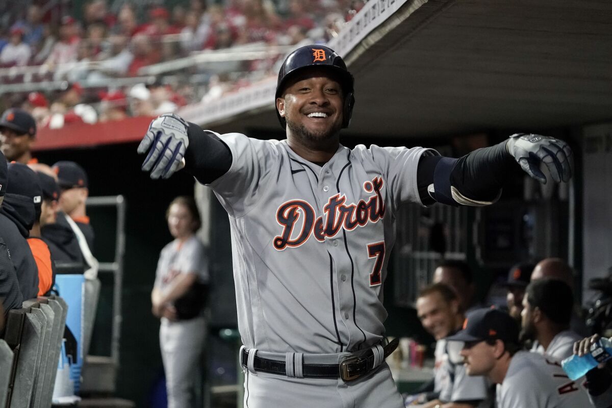 Detroit Tigers' Jonathan Schoop (7) celebrates in the dugout after hitting a solo home run during the third inning of a baseball game against the Cincinnati Reds, Friday, Sept. 3, 2021, in Cincinnati. (AP Photo/Jeff Dean)