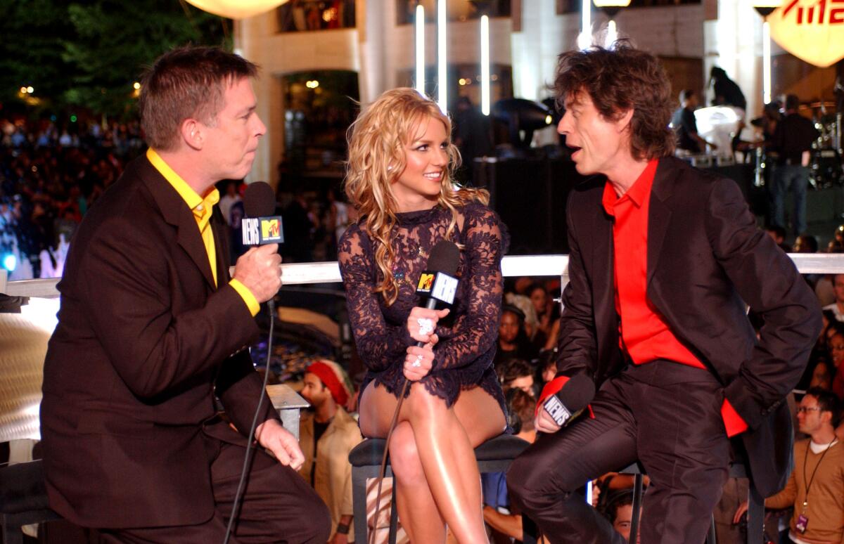 three people sit on stools with mics