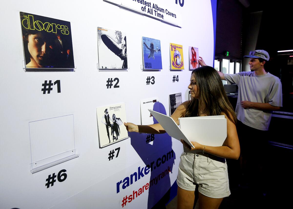 Lindsey Lopez arranges her favorite album covers on the popular "ranker board" at the Art of Music Experience on Thursday.