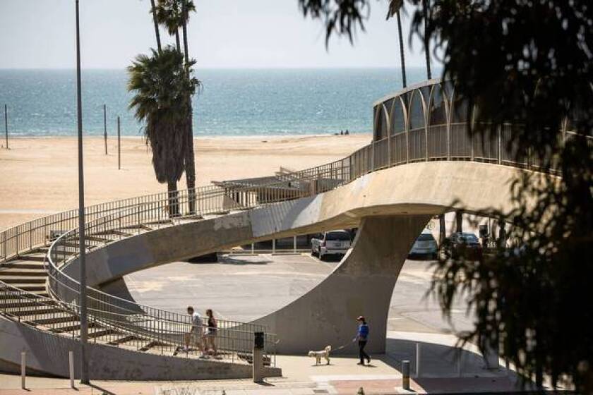 A wide spiral stairway crosses over Pacific Coast Hghway and onto the bluffs above the beach.