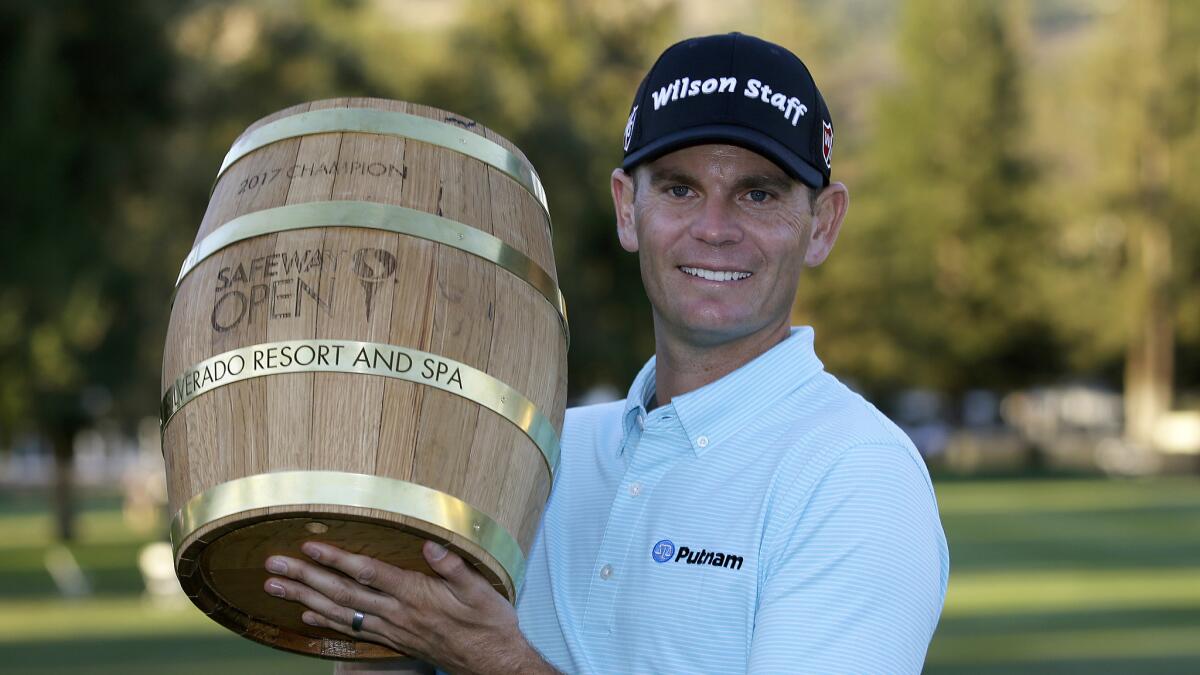 Brendan Steele poses with his trophy on the 18th green of the Silverado Resort North Course after winning the Safeway Open on Sunday.