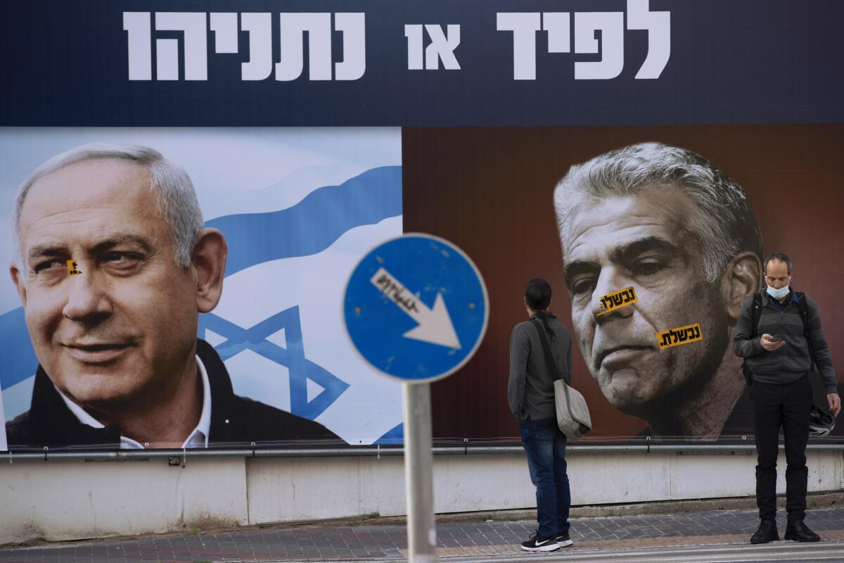 Campaign billboards showing Benjamin Netanyahu and Yair Lapid in Israel