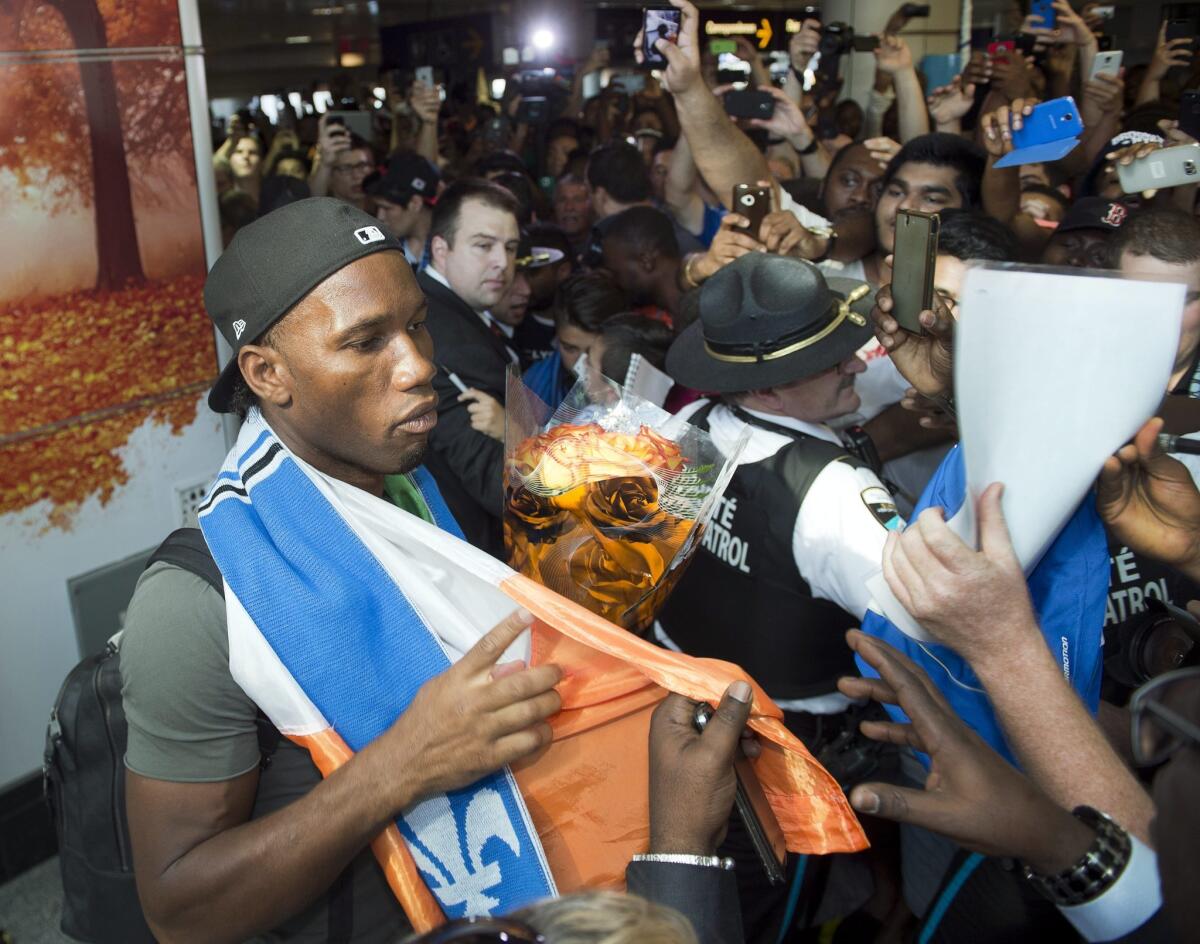 Montreal Impact's new soccer player Didier Drogba is greeted by fans as he arrives at Pierre Elliott Trudeau International Airport in Montreal, Wednesday, July 29, 2015. (Ryan Remiorz/The Canadian Press via AP) MANDATORY CREDIT