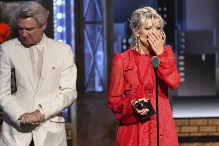 Anais Mitchell accepts the award for best original score for "Hadestown" at the 73rd annual Tony Awards at Radio City Music Hall on Sunday, June 9, 2019, in New York. At left is presenter David Byrne. (Photo by Charles Sykes/Invision/AP)