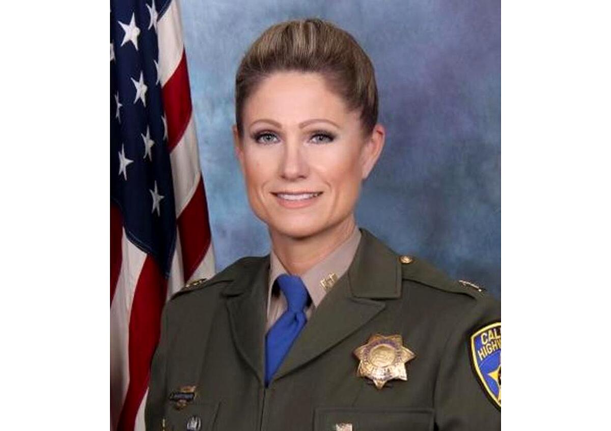 A woman in a law enforcement uniform.
