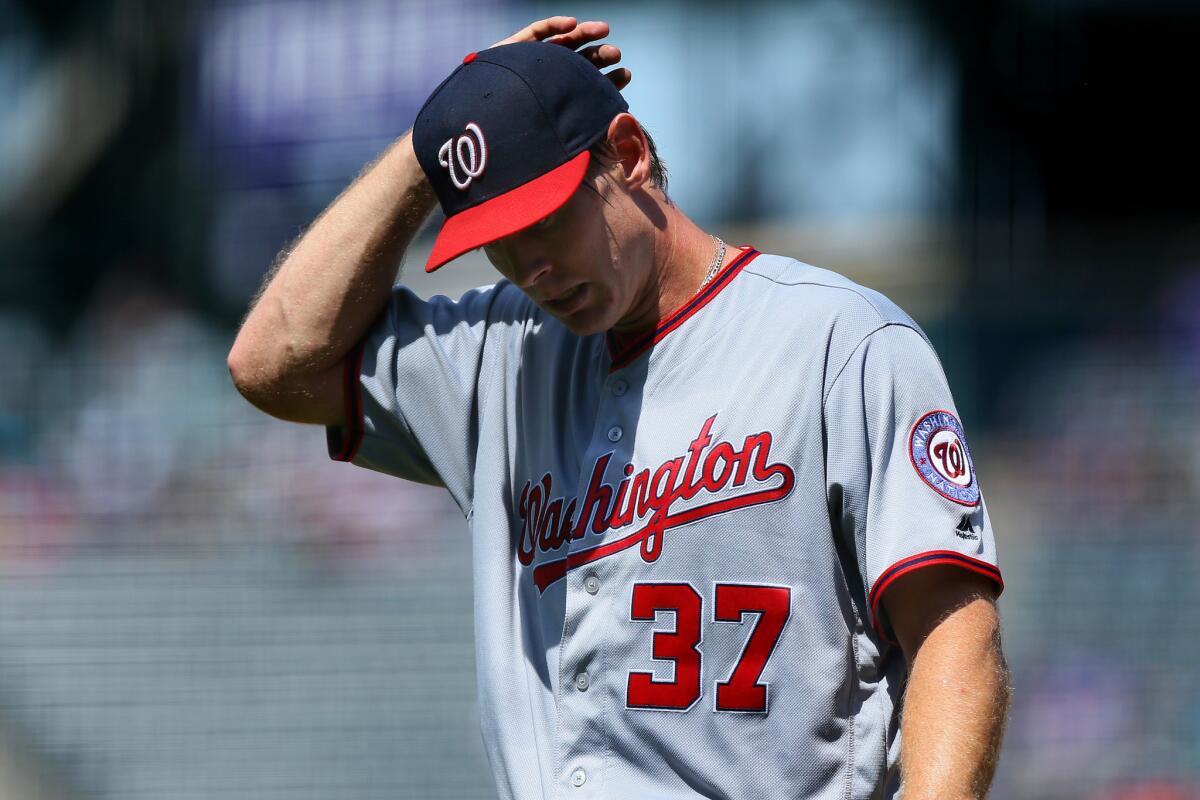 Nationals starting pitcher Stephen Strasburg (37) walks off the field after allowing seven earned runs in the first inning against the Rockies on Aug. 17.