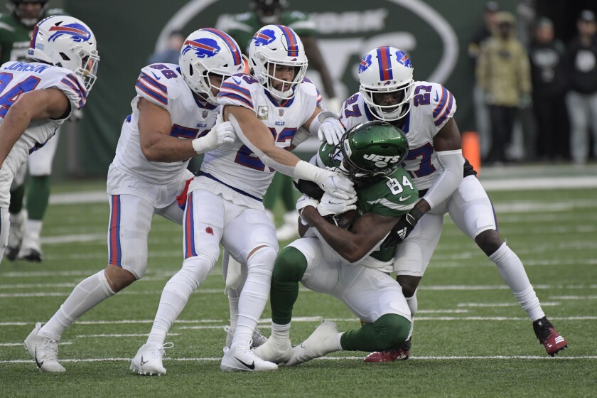 Buffalo Bills defensemen tackle New York Jets' Corey Davis, second from right, during the second half of an NFL football game, Sunday, Nov. 14, 2021, in East Rutherford, N.J. (AP Photo/Bill Kostroun)