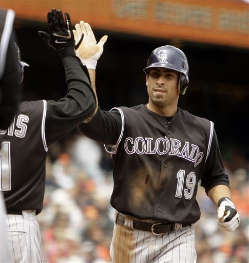 Colorado Rockies' Ryan Spilborghs (19) celebrates with teammate Jason Marquis after hitting a two-run home run off San Francisco Giants' Matt Cain during the fifth inning of a baseball game Saturday, May 2, 2009, in San Francisco. (AP Photo/Ben Margot)