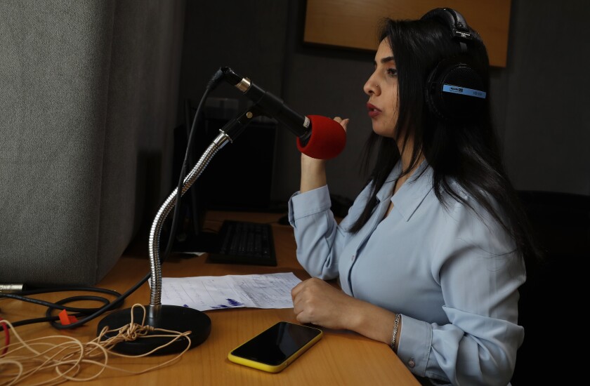 Palestinian journalist Rewaa Mershid works at the studio of ZMN FM radio station in Gaza City, Thursday, May 6, 2021. Mershid, a 26-year-old reporter for a local radio station, was with colleagues filming at a privately owned farm near the heavily guarded Gaza frontier on April 25 when two members of a Hamas-run border patrol approached and asked them to identify themselves. (AP Photo/Adel Hana)