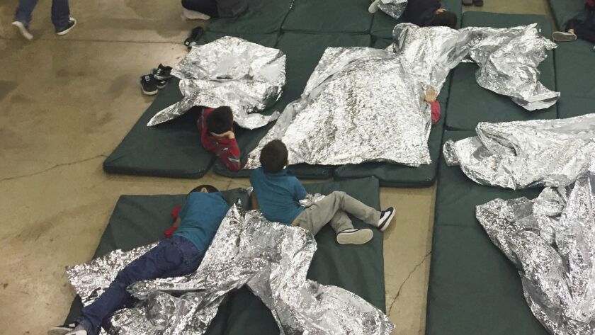 Children who've been taken into custody related to cases of illegal entry into the U.S. sit inside a facility in McAllen, Texas.