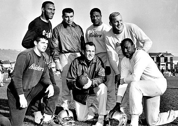 Oakland coach and general manager Al Davis, holding football, joins Raiders players named to the Associated Press 1963 American Football League All-Star team. From left are defensive halfbacks Tommy Morrow and Fred Williamson, linebacker Archie Matsos, halfback Clem Daniels, center Jim Otto and end Art Powell.