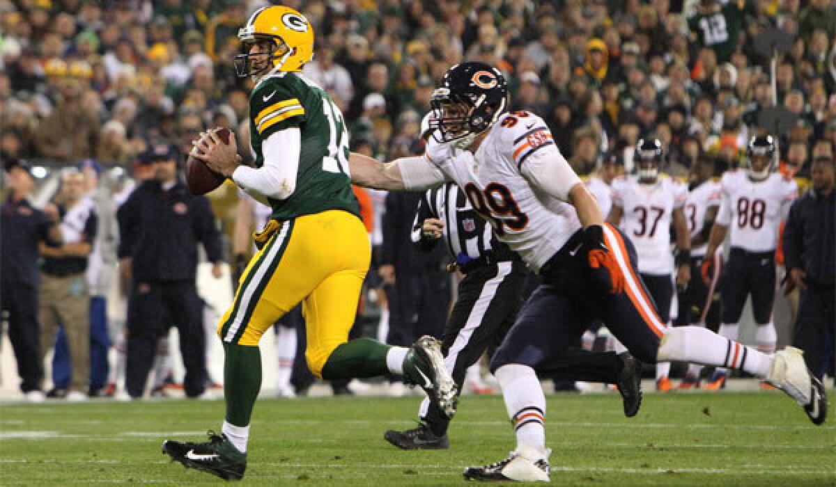 Chicago's Shea McClellin chases Green Bay's Aaron Rodgers at Lambeau Field.