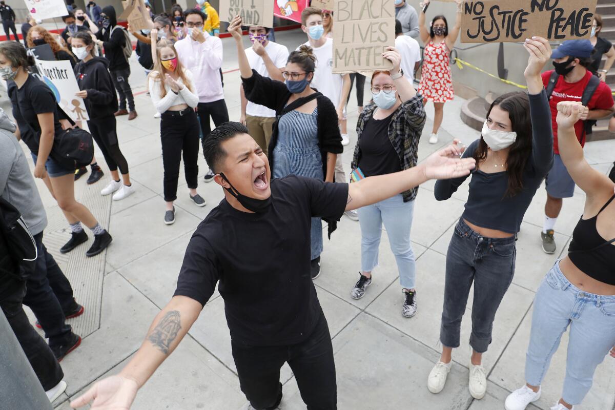 Demonstrator George Alvarado, 26, of Fountain Valley shouts "No justice! No peace!"