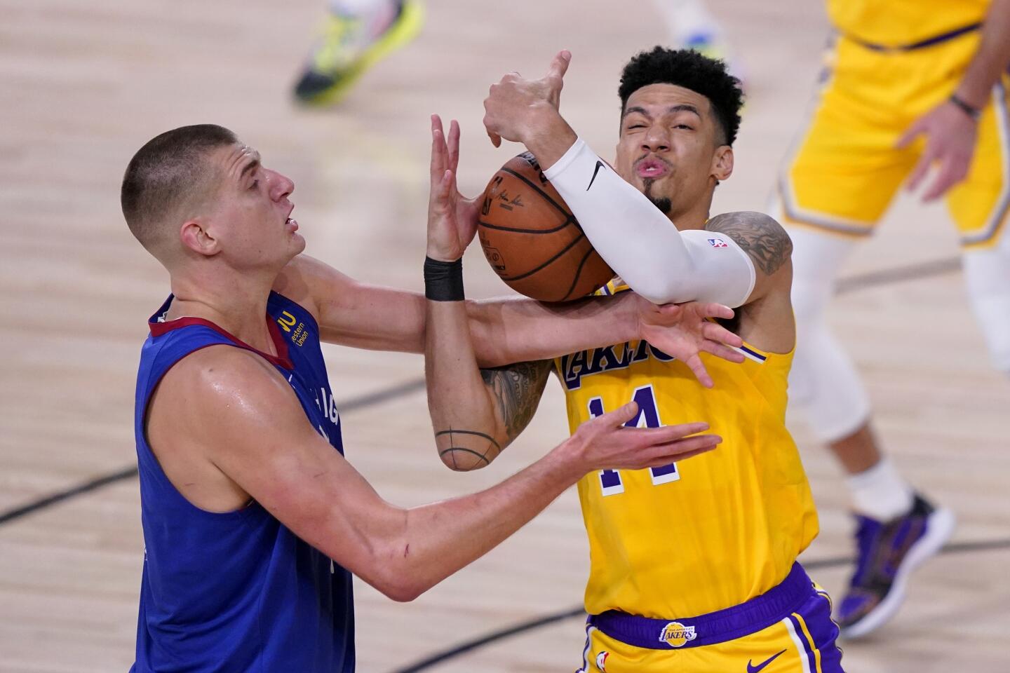 Lakers guard Danny Green battles Nuggets center Nikola Jokic for a rebound during Game 1.