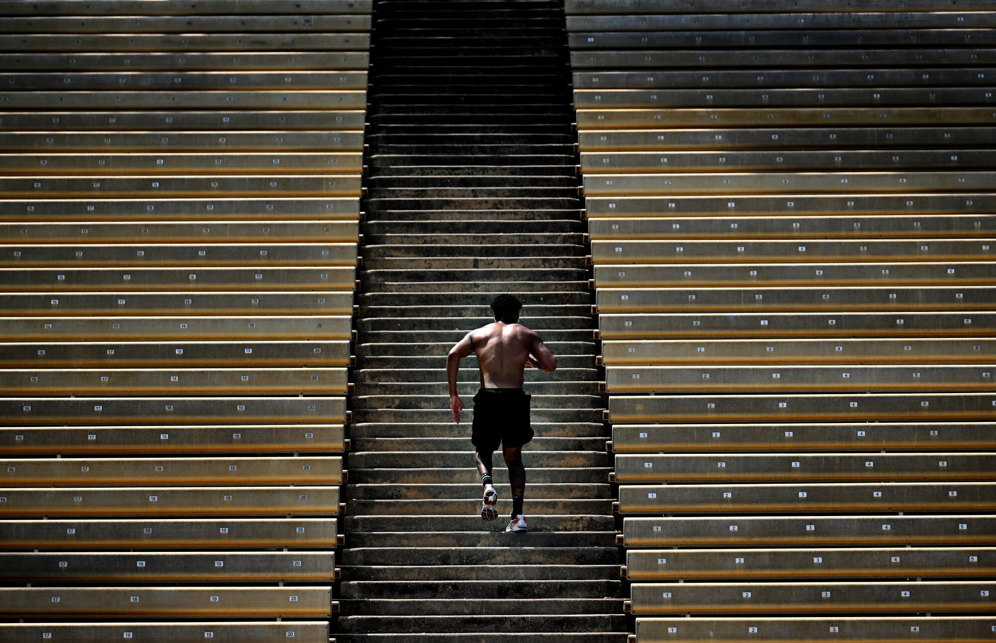 Boxer Devin Haney runs up the stadium stairs at Drake Field on the UCLA campus.