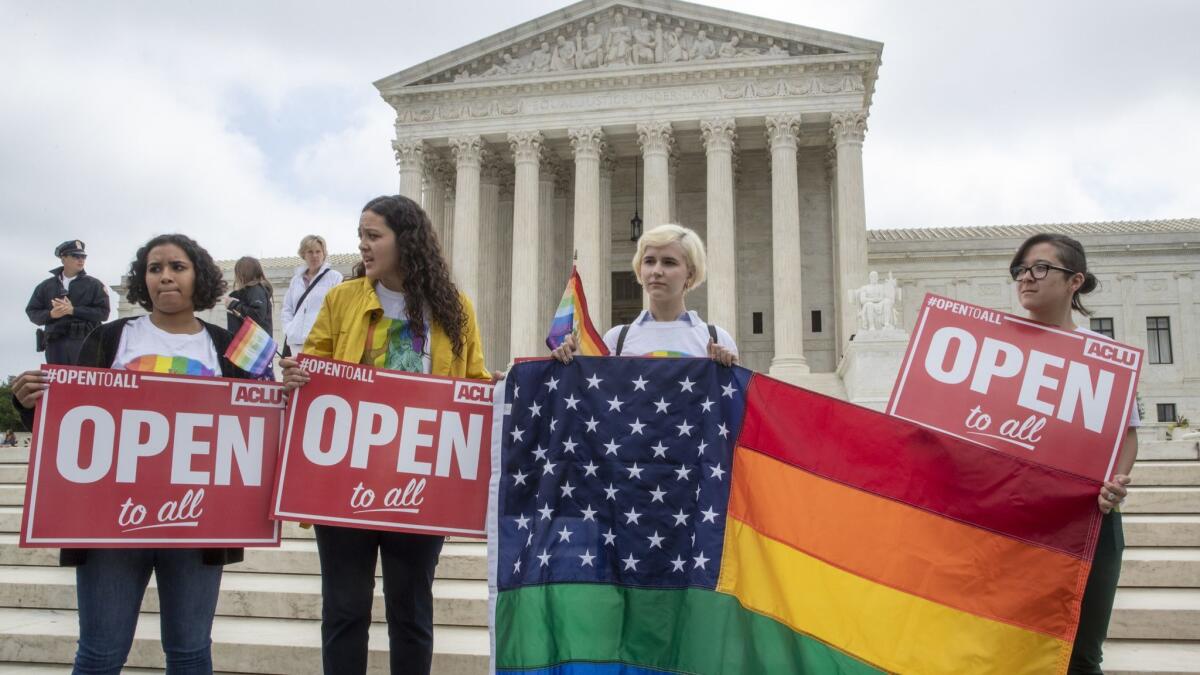 American Civil Liberties Union activists demonstrate in front of the Supreme Court in Washington on June 4, 2018.