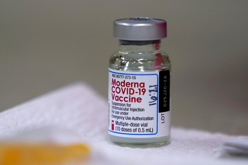 A bottle of Moderna's COVID-19 vaccine is seen on a table before Kansas Democratic Gov. Laura Kelly received an injection Wednesday, Dec. 30, 2020, in Topeka, Kan. (AP Photo/Charlie Riedel)