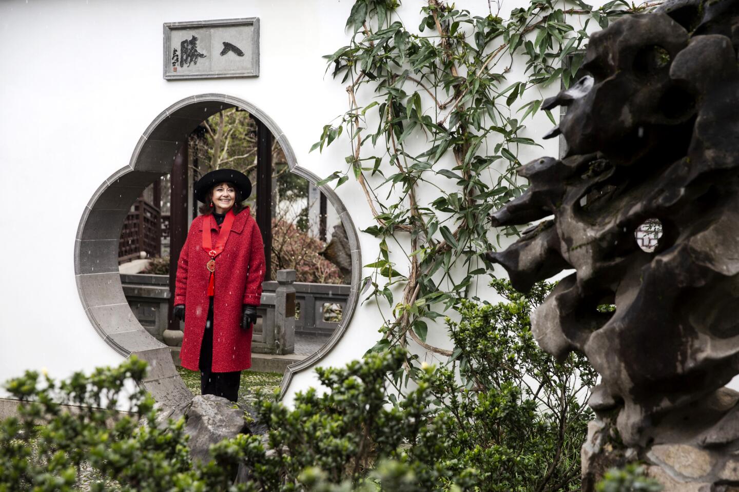 Lucinda Pierpont, a tour guide since the Lan Su Chinese Garden opened 20 years ago, poses in the garden.