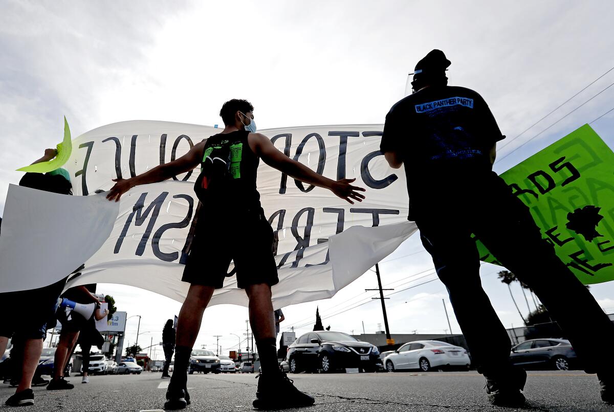 Protesters gather near Figueroa Street and Redondo Beach Boulevard Friday afternoon.