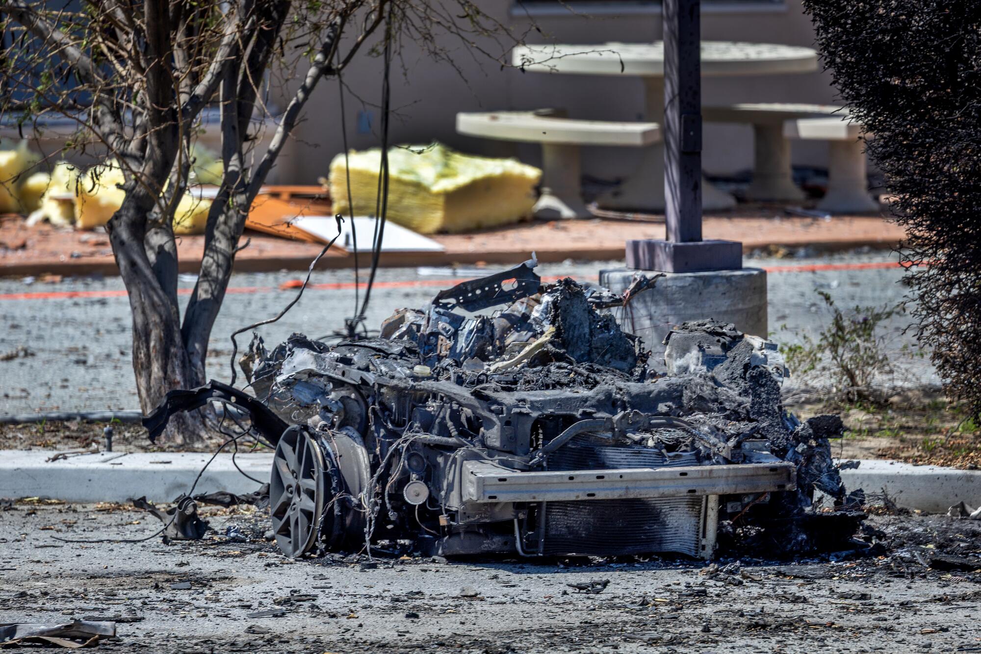 The remains of the car used in Saturday's bomb attack sit in a twisted pile of wire and metal.