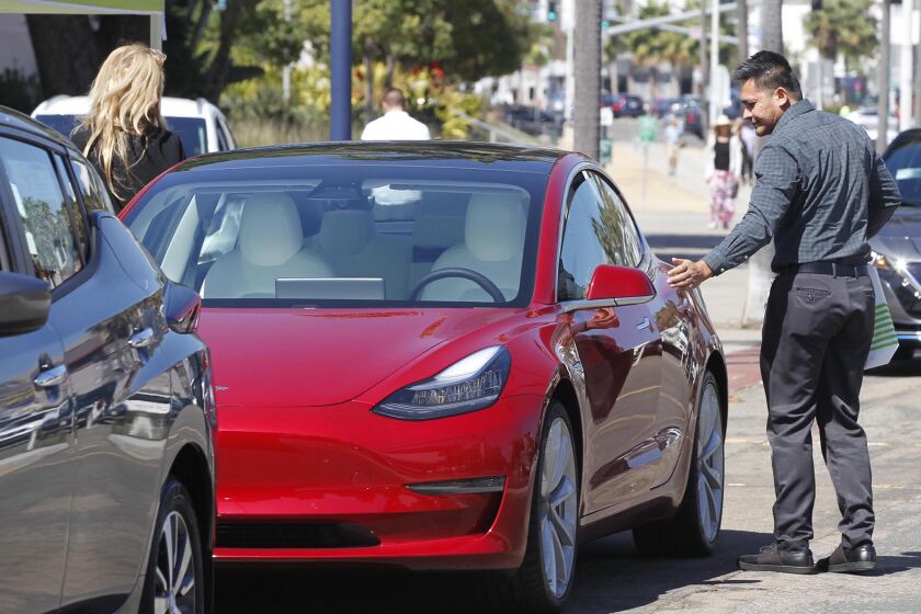 County worker Oliver Devera, right, got out of the drivers side of a Tesla Model 3 after taking a test drive. A free electric vehicle "Drive and Ride" event was held at the County Administration Building on Wednesday, October 2, in recognition of California's Clean Air Day. The public was able to test drive one or all of the electric cars to see if it was something they would change to in the future. The event was organized by Supervisor Nathan Fletcher.