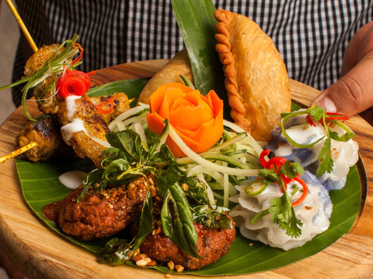 Jan ruam mit, Galangal's Thai platter, features Thai fish cake, Thai curry puff, Thai chicken satay and chor mung flower dumplings.