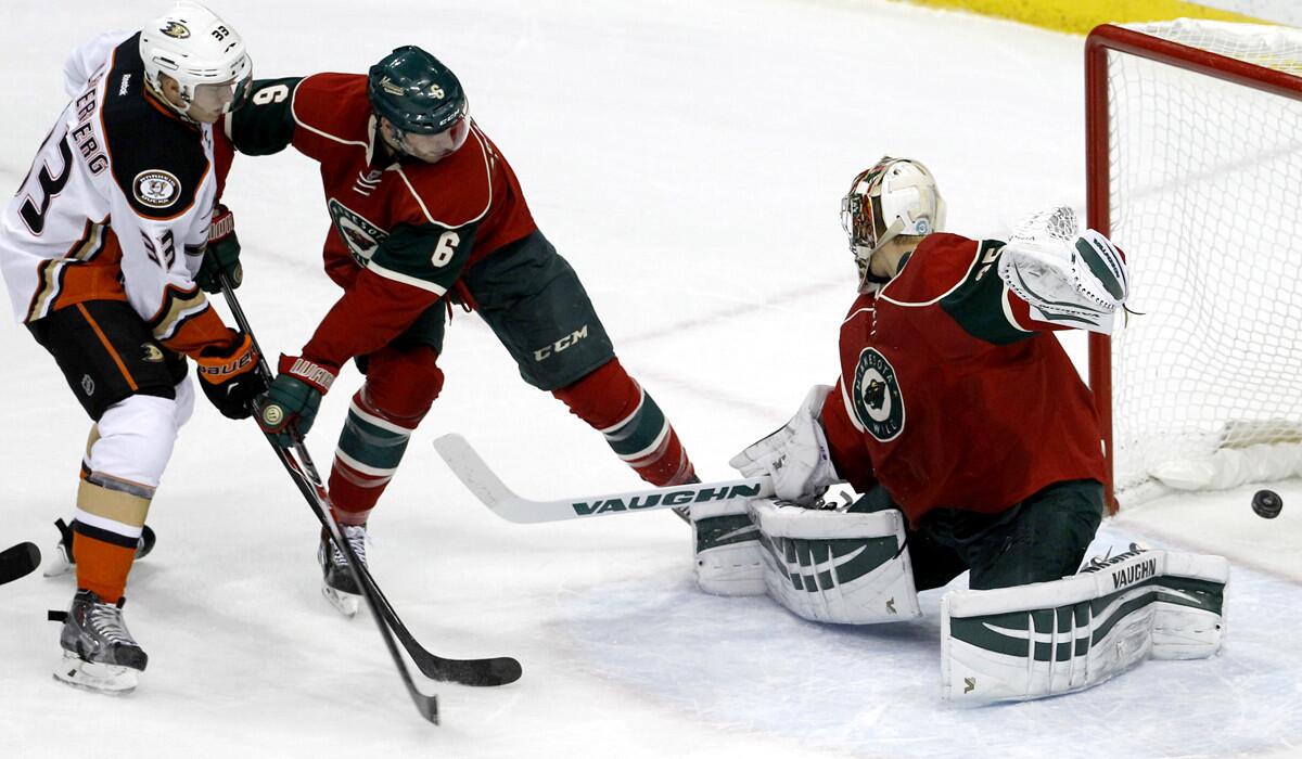 Ducks right wing Jakob Silfverberg (33) scores against Wild goalie Darcy Kuemper despite the efforts of defenseman Marco Scandella (6) in the first period Friday night.